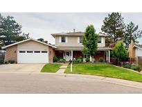 Charming two-story home with a well-manicured lawn and a two-car garage at 6278 E Euclid Ave, Centennial, CO 80111
