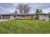 Charming single-story home with a well-manicured lawn and inviting curb appeal at 10698 W 26Th Ave, Lakewood, CO 80215