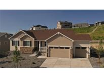 Beautiful, two-car garage home featuring stone accents, stylish curb appeal, and a well-maintained landscape at 4121 River Oaks St, Castle Rock, CO 80104