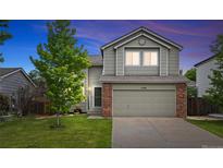 Charming two-story home with a well-maintained lawn and a two-car garage, perfect for Gathering living at 11188 Latigo Ln, Parker, CO 80138