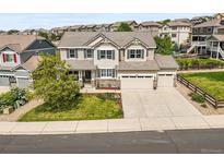 Inviting two-story home featuring a three-car garage, well-manicured lawn, and beautiful landscaping at 2090 Bellavista St, Castle Rock, CO 80109