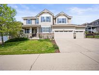 Beautiful two-story home with a three-car garage and manicured lawn in a desirable neighborhood at 2090 Bellavista St, Castle Rock, CO 80109