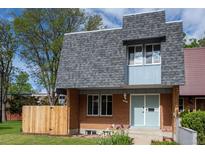 Charming two-story home with brick facade, gray roof, and well-maintained front yard at 11651 Pennsylvania St, Northglenn, CO 80233