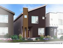 Modern two-story home with a combination of vertical and horizontal paneling and simple landscaping at 1577 W 166Th Ave, Broomfield, CO 80023
