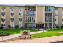 Building exterior, showcasing landscaping and building number 202 at 13606 E Bates Ave # 208, Aurora, CO 80014