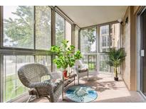 Relaxing sunroom with wicker furniture and a view of the outdoors at 13606 E Bates Ave # 208, Aurora, CO 80014