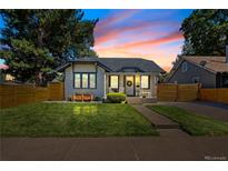 Charming single-story home with a well-manicured lawn and cozy front porch, framed by mature trees and a sunset sky at 4312 Xavier St, Denver, CO 80212