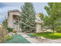 Inviting two-story home with a well-manicured lawn and attractive landscaping at 6598 S Telluride St, Aurora, CO 80016