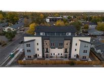 Modern townhome boasts a stylish facade, stone accents, and a private entrance, perfect for urban living at 1524 Ingalls St, Lakewood, CO 80214