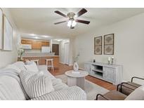 Inviting living room flows into the kitchen with hardwood floors and natural light at 9650 Huron St # 12, Thornton, CO 80260