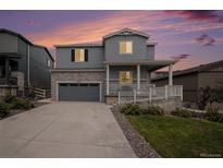 Charming two-story home with stone accents, a covered porch, and well-maintained landscaping at 5201 Lumos Ln, Castle Rock, CO 80104