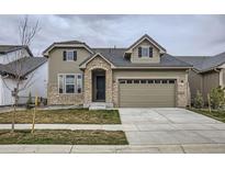 Charming two-story home featuring stone accents, a two-car garage, and well-maintained lawn at 3140 Newfound Lake Rd, Berthoud, CO 80513