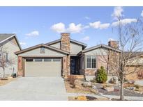 Ranch style home with stone accents and a two-car garage at 12597 W Big Horn Cir, Broomfield, CO 80021