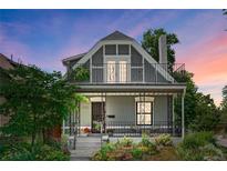 Charming two-story home featuring a welcoming front porch and upper balcony, complemented by lush landscaping at 4363 N Raleigh St, Denver, CO 80212