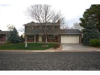Charming two-story brick home featuring a well-maintained lawn and a spacious two-car garage at 978 Mercury Cir, Lone Tree, CO 80124