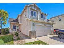 Charming two-story home with a well-maintained lawn, driveway, and a two-car garage at 10521 Taylor Ave, Firestone, CO 80504