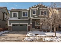 Two-story house with green siding, stone accents, and a two-car garage at 40 Ferris Ln, Erie, CO 80516