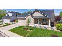 Charming single-Gathering home boasts a well-manicured lawn, a two-car garage and a welcoming front porch at 14833 Vine St, Thornton, CO 80602