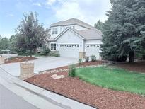Charming two-story home featuring a three-car garage and well-manicured landscaping at 22019 E Arbor Dr, Aurora, CO 80016
