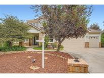Charming two-story home featuring a well-maintained yard, mature trees and a two car garage at 22019 E Arbor Dr, Aurora, CO 80016