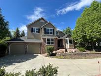 Charming two-story home featuring a three-car garage and a well-maintained, landscaped front yard at 2522 W Dry Creek Ct, Littleton, CO 80120