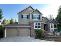 Charming two-story home featuring a brick facade and well-maintained landscaping at 2522 W Dry Creek Ct, Littleton, CO 80120