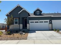 Charming one-story home with grey siding, white trim, a two-car garage, and beautifully landscaped front yard at 3401 N Denali St, Aurora, CO 80019
