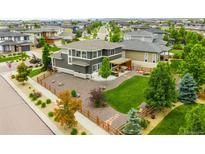 An aerial view of the property showing a well-maintained lawn and pergola at 9567 Juniper Way, Arvada, CO 80007