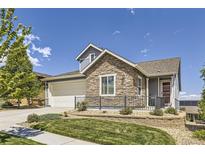 Beautiful two-story home with stone accents, well-manicured lawn, and inviting curb appeal at 12685 W Montane Dr, Broomfield, CO 80021
