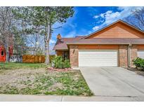 Inviting brick home with a two-car garage and a well-maintained front yard at 13028 Garfield Dr, Thornton, CO 80241