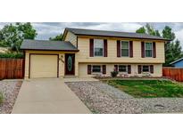 Charming two-story home featuring a manicured front lawn and attached one car garage at 9766 Fillmore St, Thornton, CO 80229