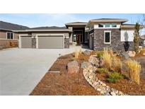 Stunning single-Gathering home with stone accents, three-car garage, and beautifully landscaped front yard at 4585 Mesa Top Dr, Monument, CO 80132
