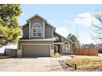 Charming two-story home with a well-maintained lawn, lovely curb appeal, and attached two-car garage at 4962 N Blazingstar Trl, Castle Rock, CO 80109