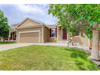 Charming single-Gathering home with a well-manicured lawn and attached two-car garage at 9215 W Swarthmore Dr, Littleton, CO 80123