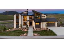 Stunning modern home with clean lines, stone accents, and professional landscaping at 5815 Peppy San Cir, Sedalia, CO 80135