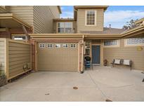 Inviting townhouse featuring an attached garage and a cozy front porch with space for seating and a grill at 12856 King St, Broomfield, CO 80020