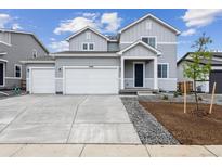 Charming two-story home featuring a spacious three-car garage and inviting front yard at 14400 Heritage Dr, Mead, CO 80504