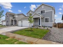 Charming two-story home featuring a two-car garage, manicured lawn, and welcoming entrance at 14400 Heritage Dr, Mead, CO 80504
