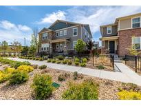 Beautiful two-story home with stone accents, manicured landscaping, and a black metal fence at 1126 S Yampa St, Aurora, CO 80017
