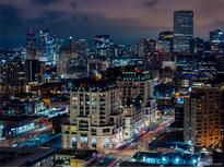 Stunning nighttime view of the city skyline with illuminated buildings and bustling streets at 975 N Lincoln St # 10A, Denver, CO 80203