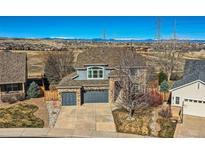 Beautiful two-story home with a well-manicured lawn, complemented by a two car garage and mountain views at 16333 Prairie Farm Cir, Parker, CO 80134