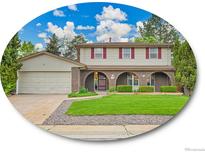 Charming two-story home featuring a manicured lawn, brick accents, and a spacious attached garage at 4670 E Euclid Cir, Centennial, CO 80121