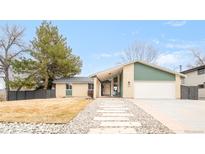 Charming home featuring xeriscaping, walkway, attached garage and large front yard at 102 Jackson Cir, Louisville, CO 80027