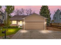 Charming single-Gathering home featuring a well-manicured lawn and attached two car garage at 9960 Garland Ln, Broomfield, CO 80021