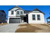 Two-story house with gray and white siding, a dark gray garage door, and a landscaped yard at 907 Congress Pl, Elizabeth, CO 80107