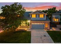Charming two-story home boasts a well-maintained lawn and an attached two-car garage at 5796 E 129Th Pl, Thornton, CO 80602