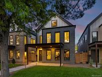 Charming modern home boasts dark brick, an inviting entrance, and professionally landscaped yard at 1612 Wolff St, Denver, CO 80204