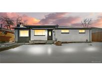 Charming single-story home with unique rock accent and covered front porch at sunset at 9300 Grove St, Westminster, CO 80031
