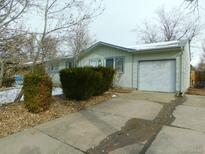 Ranch-style home with attached garage and well-maintained landscaping at 11621 E Ada Pl, Aurora, CO 80012