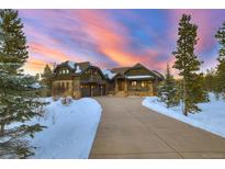 Stunning front exterior of a multi-story home with an attached garage and a long driveway at 219 Glen Eagle Loop, Breckenridge, CO 80424